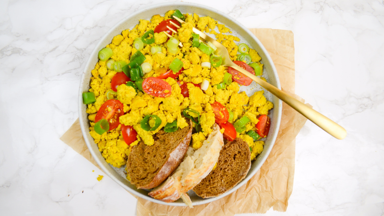 plate on a table with tofu scramble bread and mixed vegetables